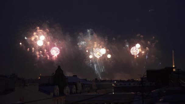 Světlé barevné záblesky v temné zatažené obloze. Zobrazit v aplikaci fireworks z budovy. — Stock video