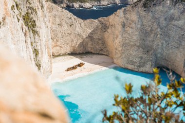 Navagio plaj tarafından büyük beyaz kayalıklarla çevrili turkuaz mavi deniz suyu ile ünlü gemi enkazı. Ünlü dönüm noktası konumu adada Zakynthos, Yunanistan. Yaprakları arasında vurdu Farme