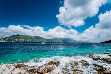 Fiskardo, Kefalonia, Yunanistan Ionian Islands yakınındaki güzel cennet. Kristal berraklığında şeffaf mavi turkuaz deniz mavisi Akdeniz deniz suyu Fiskardo şehirde. Beyaz Katamaran yat yarışı açık denizde