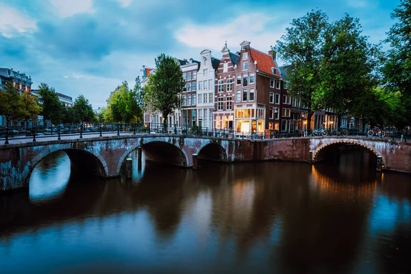 Famoso canal Keizersgracht Emperors en Amsterdam, paisaje holandés con puente iluminado en el crepúsculo, Países Bajos — Foto de Stock