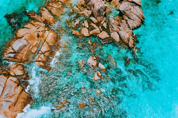 Vista aérea superior das ondas do oceano atingindo rochas de granito na praia em La Digue, Seychelles — Fotografia de Stock