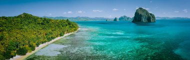 Panoramic drone aerial view of coastal scenery from the mainland Palawan with tropical Pinagbuyutan islands on horizon. El Nido-Philippines. Best natural wonder in Southeast Asia Bacuit archipelago clipart
