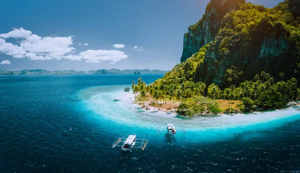 Turkuaz mavi okyanus suyu ile çevrili pastoral Ipil plaj ile tropikal pinagbuyutan Adası gelen turist tekneleri Epic hava drone panoramik resmi. El Nido, Palawan, Filipinler