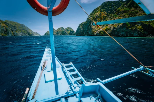 Island hopping Tour C, boat approaching world famous touristic spot locations, travel tour trip explore El Nido, Philippines