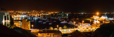 Alacakaranlıkta Mindelo şehrinin panoramik gece resmi. Cape Verde, Sao Vicente Adası'nda lagün birçok tekne ile Liman kenti
