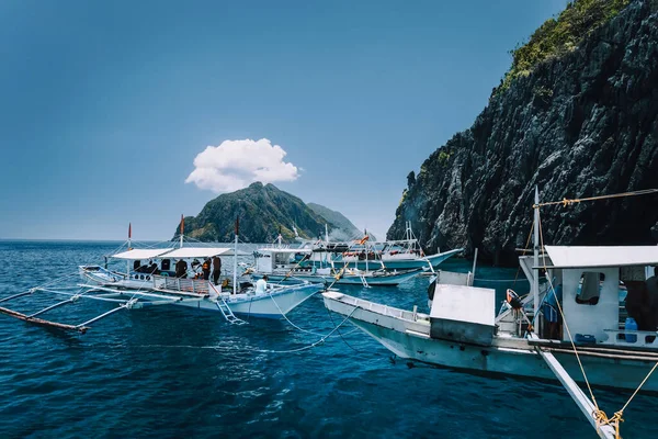 Turystyczne banca łodzie na powierzchni błękitnego morza wody na wyspie hopping wycieczki. El Nido, Palawan, Filipiny — Zdjęcie stockowe