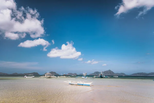 A traditional Filipino boat on an empty sandy bar.