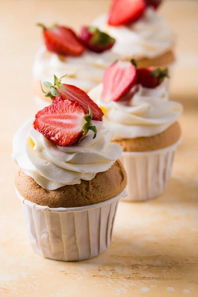 Strawberry cupcakes on yellow background