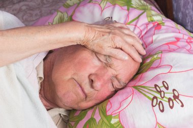 Elderly 80 plus year old man in a home bed. clipart