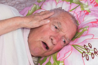 Elderly 80 plus year old man in a home bed. clipart