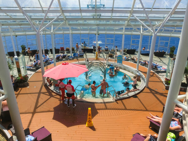 Cape Canaveral, USA - April 29, 2018: The people resting at Solarium on the Royal Carribean cruise ship Oasis of the Seas at Cape Canaveral, USA on April 29, 2018