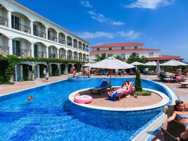 Berdyansk, Ukrayna 30 Haziran 2018: Sun Resort otel Azak Denizi Plajı'nda yüzme havuzunda dinlenme insanlar