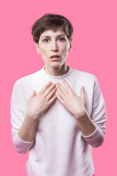 Why is that. Beautiful female half-length portrait isolated on trendy pink studio backgroud.