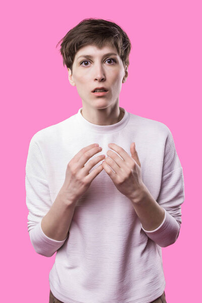 Why is that. Beautiful female half-length portrait isolated on trendy pink studio backgroud.