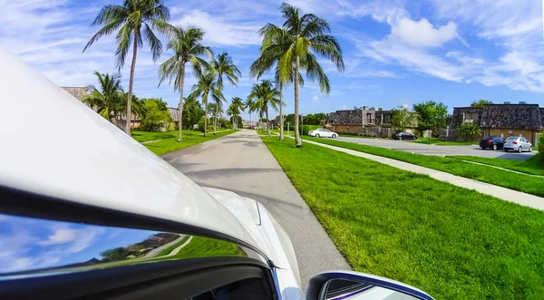 Typical Florida home in the countryside with palm trees, tropical plants and flowers