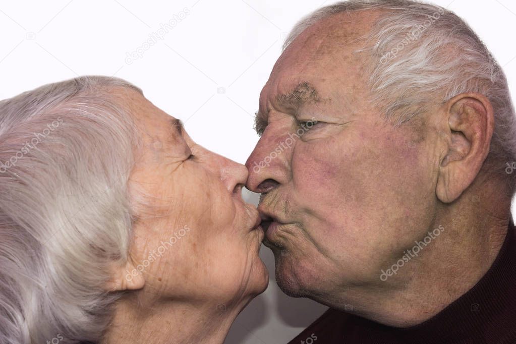 The senior woman kissing old man