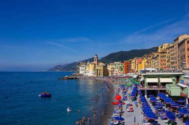 Camogli, Italy - September 15, 2019: People resting at beach at Camogli on sunny summer day clipart
