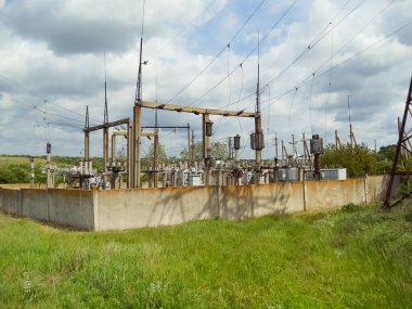 Abstracr transforner station and green grass ar background