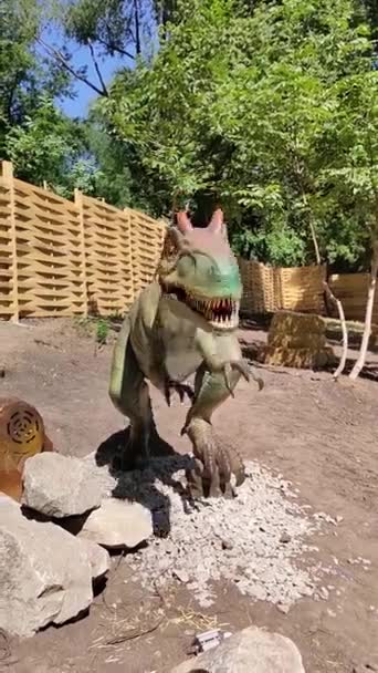 The toy dinosaur at summer park — Stock Video