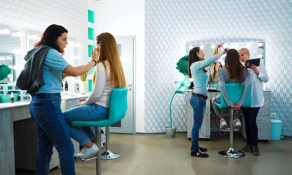 makeup and haircut specialists prepare model girls for a fashion show