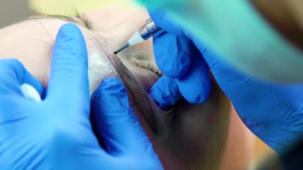 Kosmetolog gör ögonbryn microblading närbild — Stockvideo