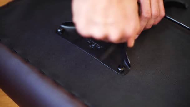 Man hands screwing new furniture with screwdriver close seup — стоковое видео