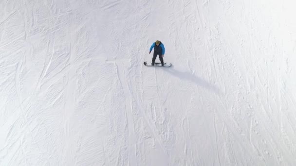 コピーや無料スペースで雪に覆われた斜面を滑るスノーボーダーのアマチュアのアンテナ — ストック動画