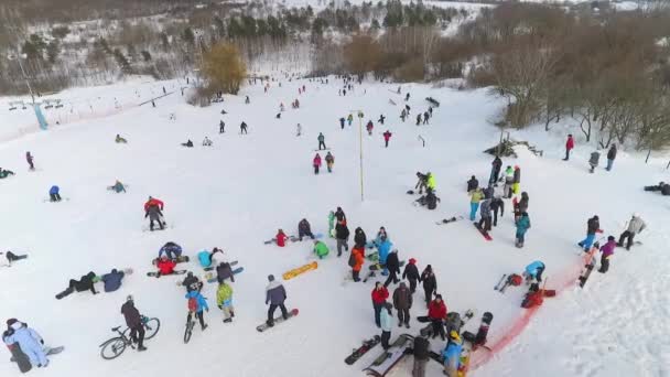 Antenn av snowboardåkare, skidåkare och mountainbikecyklister har resten ovanpå sluttningen — Stockvideo