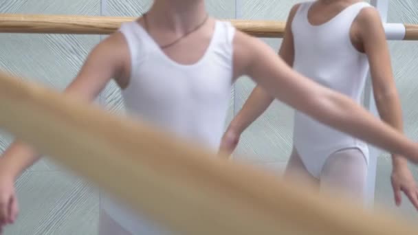 Closeup little ballerinas group in white shoes practicing in ballet school slow motion — Stock Video
