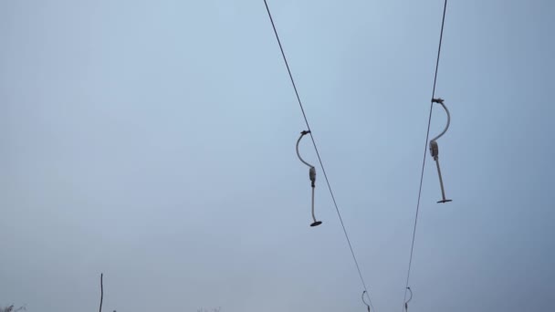 Ski lift holders swinging in the wind — Stock Video
