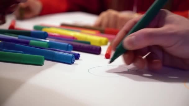 Primer plano manos dibujo en hoja de papel grande con enfoque en marcadores de color en — Vídeos de Stock