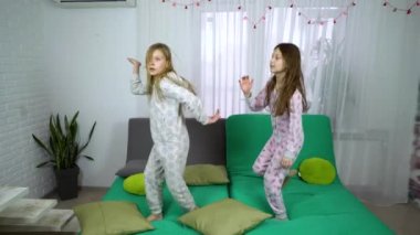 Çocuk pijama kanepenin üzerinde dans