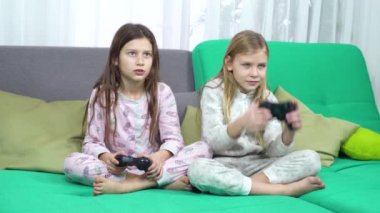 Çocuklar oyun yastıkları ile oynuyor. pijama küçük kızlar evde birlikte eğlenin. teknoloji, eğlenceli ve mutlu çocukluk