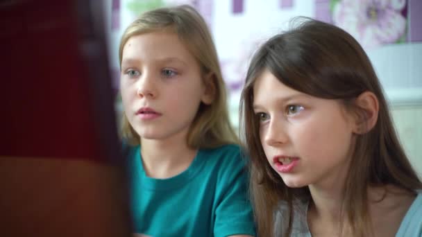 Little girls playing games together on laptop closeup — Stock Video