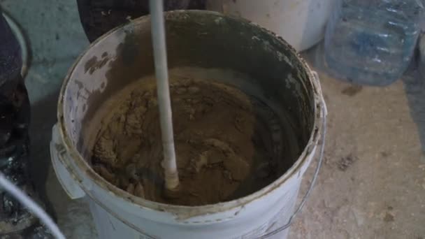 Closeup Mixing Adhesive Solution Bucket Construction Site Worker Preparing Mixture — Stock Video