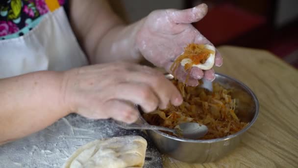 Gros plan de femmes âgées mains faisant des boulettes avec du chou rôti — Video