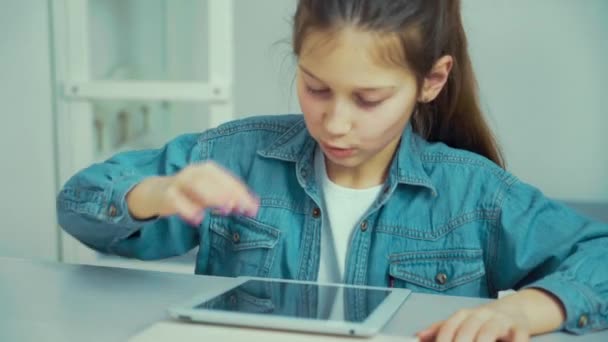 Chica caucásica en jeans desgaste jugar juegos en la tableta — Vídeos de Stock