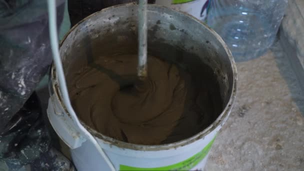 Closeup of making mortar in bucket at construction site — Stock Video