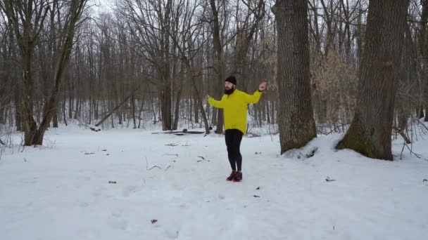 Homme en forme barbu sauter avec corde sautante dans la forêt d'hiver avec espace libre — Video