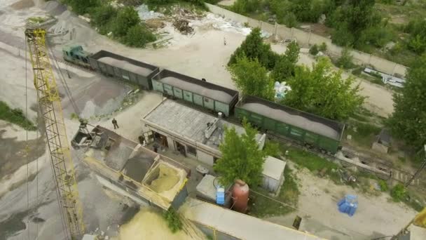 Train de marchandises transportant des décombres industriels à la vieille usine de béton plan aérien — Video