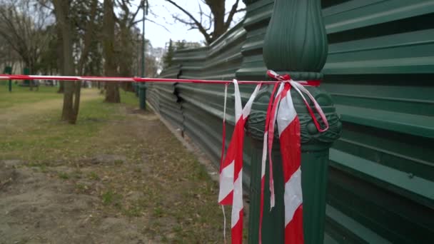 Red and white caution tape near construction site warns of restricted area — Stock Video