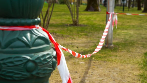 warning tape is tied to street lights near restricted area