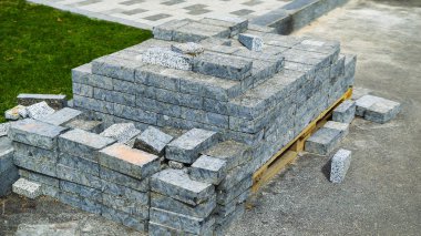 gri kaldırım taşları şehir parkında yeşil çim yakın ahşap palet üzerinde saklanır