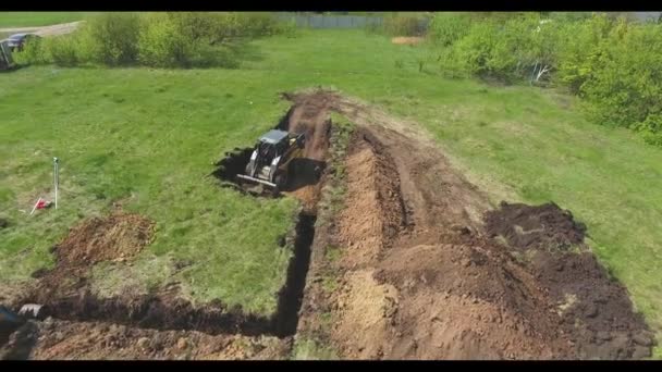 新しい家のための基礎ピットを掘る掘削機の空中 — ストック動画