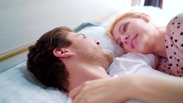 Closeup loving couple lying in bed face to face in the morning — Stock Video