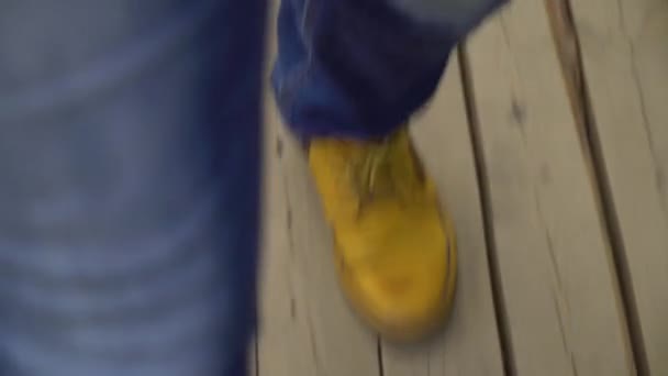 Top down shot of male feet walking on wooden decking at construction site — Stock Video