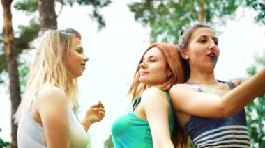 mutlu kızların düşük açı gülmek ve parkta Holi festivali nden sonra selfie yapmak
