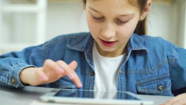 Portrait of little girl playing online games on tablet — Stock Video