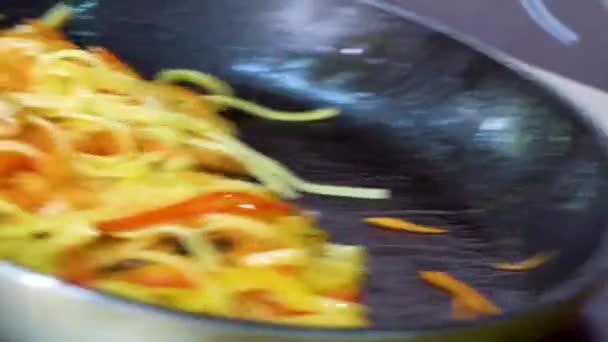 Primo piano di lancio della pasta con verdure e pezzi di pollo sulla padella — Video Stock