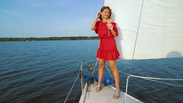 Beautiful girl enjoying marine adventure on sailing boat with wine — Stock Video